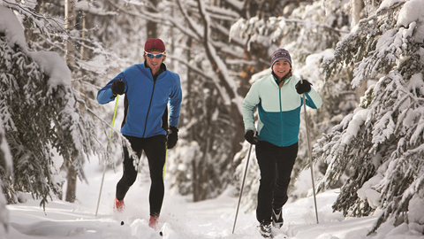 Two people cross country skiing through Olympic Valley