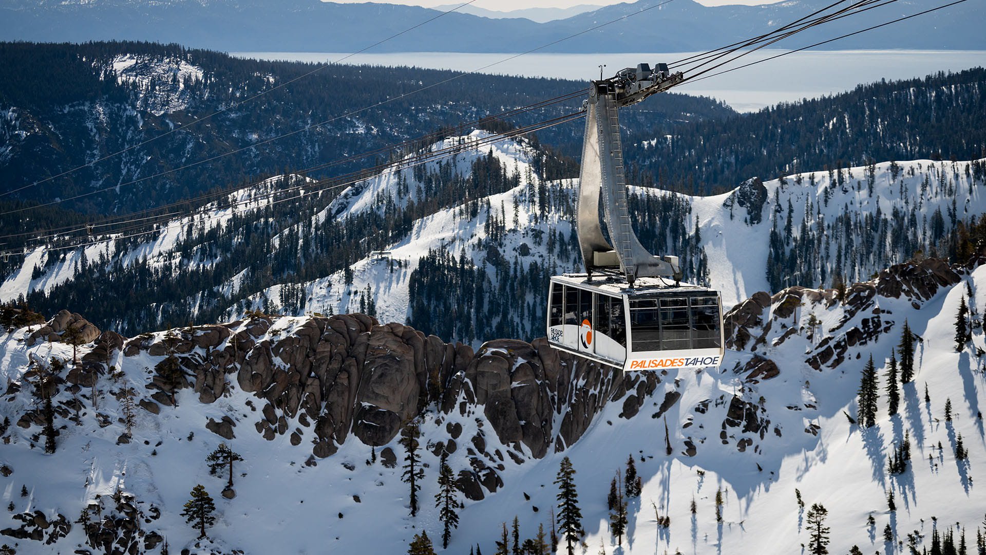 The Palisades Tahoe Aerial Tram docks at High Camp on a snowy winter day.