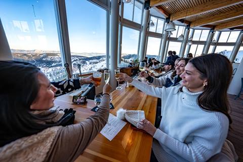Group of women doing a cheers at High Camp.