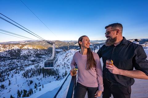 Couple smiling at High Camp overlooking snowy view