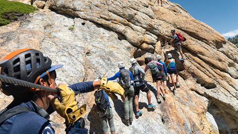 Via Ferrata group of climbers scaling a slab on Tram Face