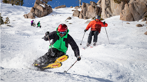 Two people skiing moguls at Palisades Tahoe