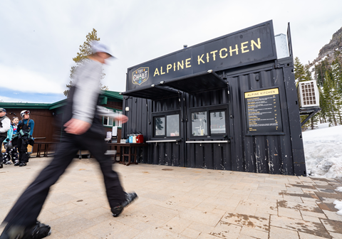 The outside of Alpine Kitchen with a person walking past