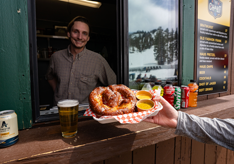 Person getting pretzel at the window at The Chalet