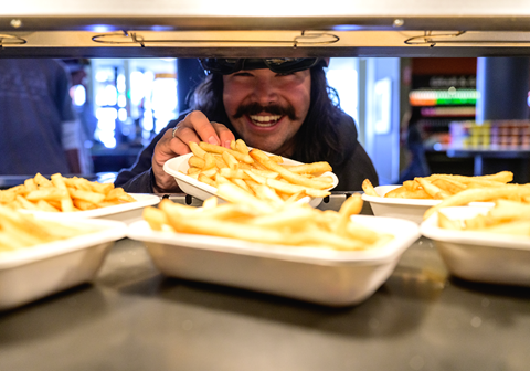 Tavo Sadeg grabbing fries at Gold Coast