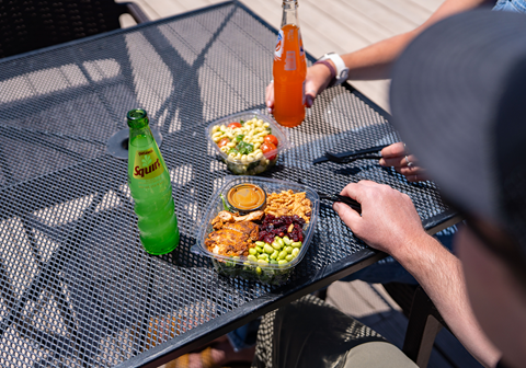 Colorful pre packaged salads and sodas from High Camp Marketplace