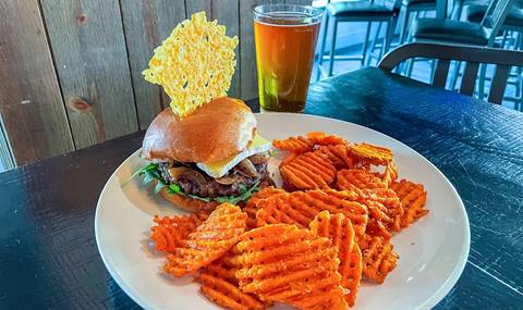 Delicious burger from Rocker served with a side of sweet potato fries