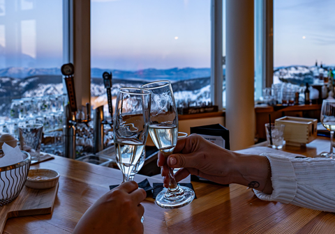 Clinking champagne glasses at Sunset Happy Hour