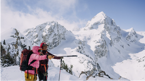 Two backcountry skiers scoping out their line