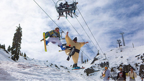 Skiers hitting spreadeagle airs at Pain McShlonkey