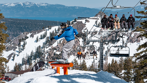 Skiers ski sliding the S rail