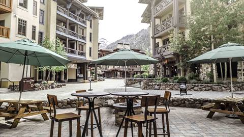 The patio in front of The Auld Dubliner on a summer day in The Village at Palisades Tahoe.