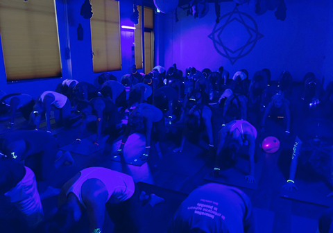 Yoga class participants with neon accessories