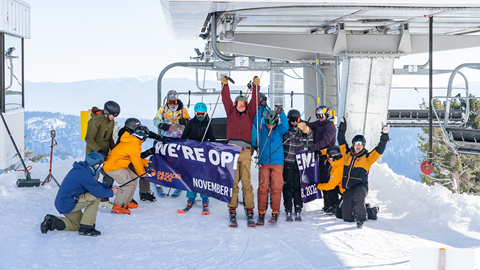 Skiers and riders getting off the chairlift on Opening Day