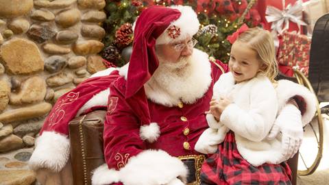 Santa read book to child.