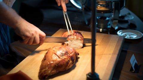Chef cutting turkey at Thanksgiving Dinner