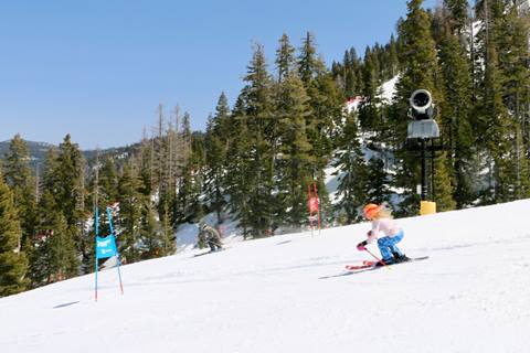 Skier racing down the hill at Peak 2 Peak