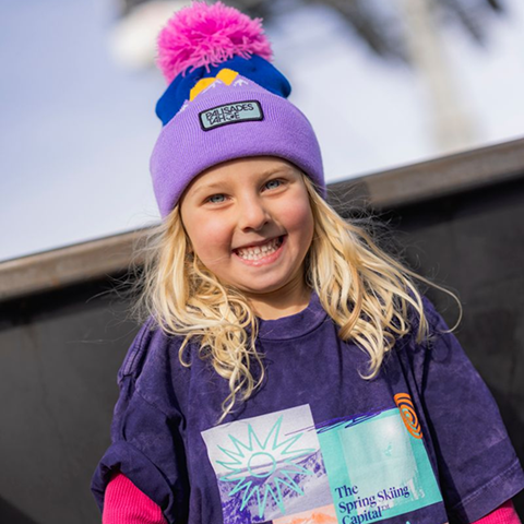 Girl smiling at camera wearing Palisades Tahoe merch