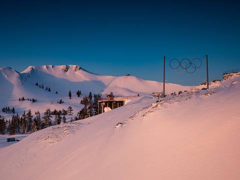View of the Olympic Rings at High Camp during a snowy sunset