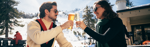 Couple enjoying apres on the Apex Lounge sun deck