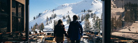 Couple holding hands and looking at the view off Oro Bar - An Apex Offering