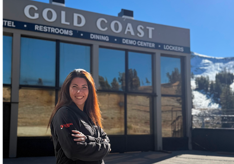 Luz Colombo, General Manager of Gold Coast, smiling in front of Gold Coast