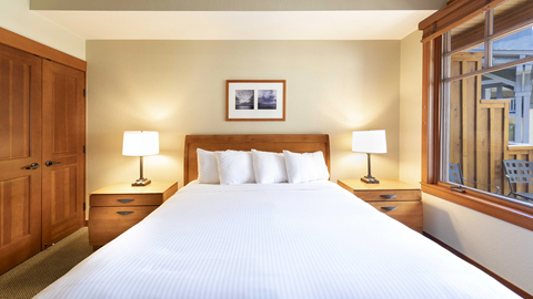 Photo of Palisades Tahoe Standard Suite king-sized bed. 