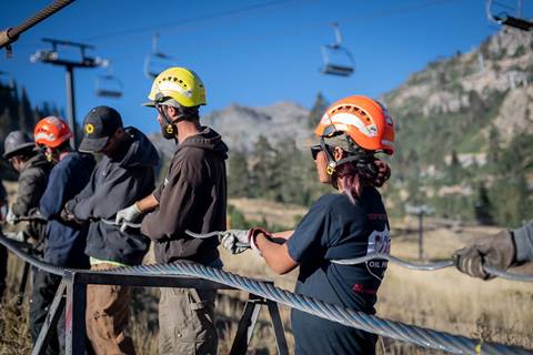 Maintenance workers do the cable splice for the Base to Base Gondola in October 2022.