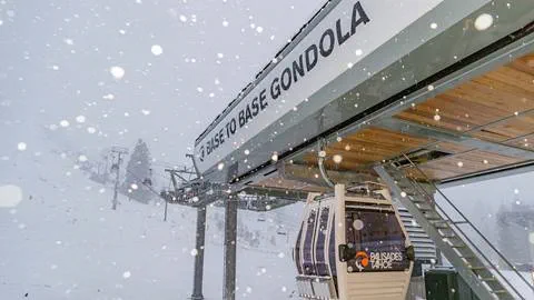 New snow falls on the Base to Base Gondola at Palisades Tahoe on December 1st.
