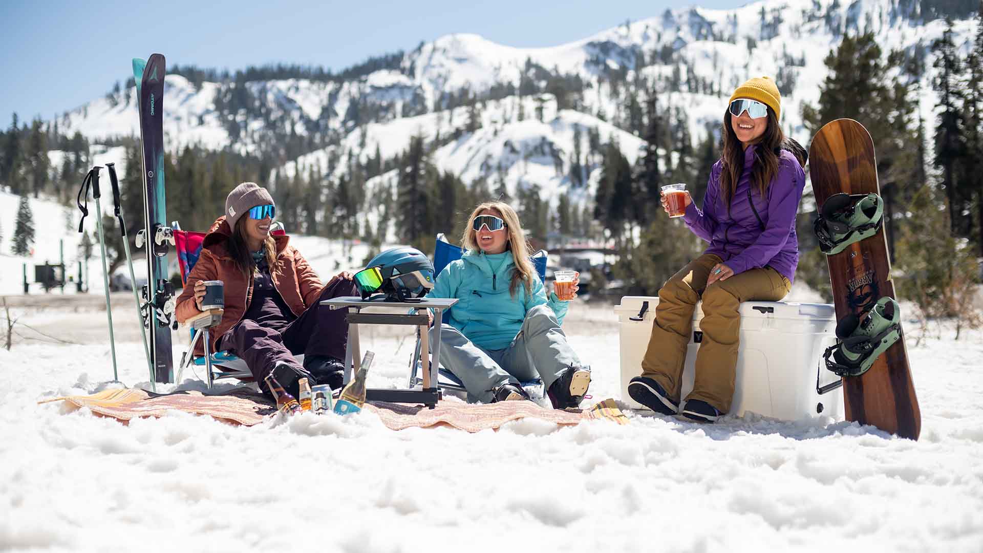 Three women relaxing outside Ice Bar on the Sherwood side of Alpine.