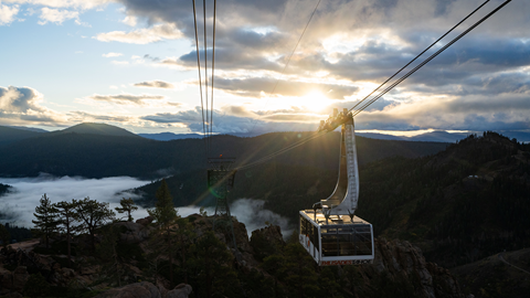 Aerial Tram rising over Olympic Valley with winter mist.