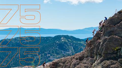 Competitors in the Broken Arrow running race ascend a latter up a steep rocky face