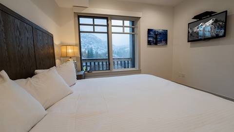 King sized bed with beautiful view overlooking the valley from the Granite Peak Terrace room.