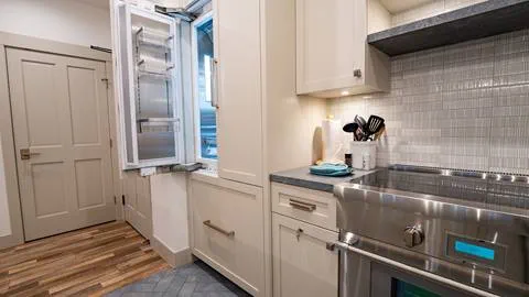 Kitchen image with fridge and stovetop inside of the Granite Peak Terrace room.