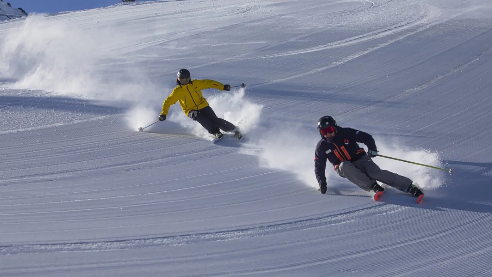 Skiers riding down hill