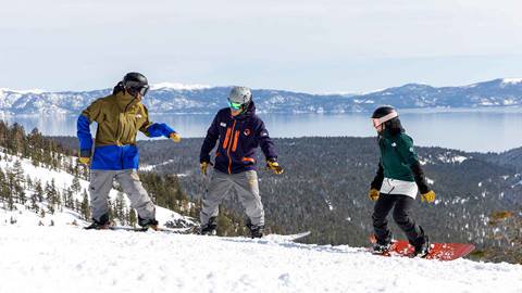 Two snowboarders with an instructor at the top of Lakeview at Alpine.