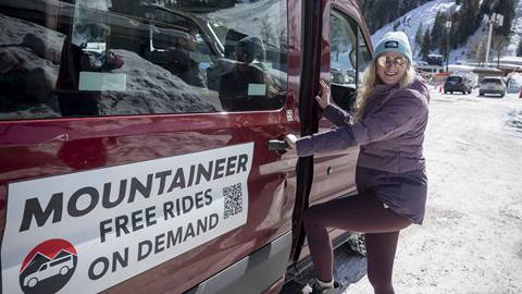 A woman getting into a Mountaineer van.