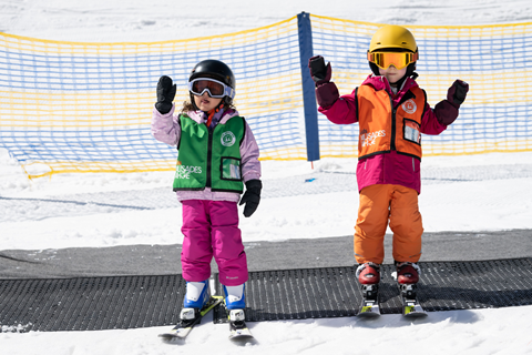 Two kids posing for a picture at Palisades Tahoe 