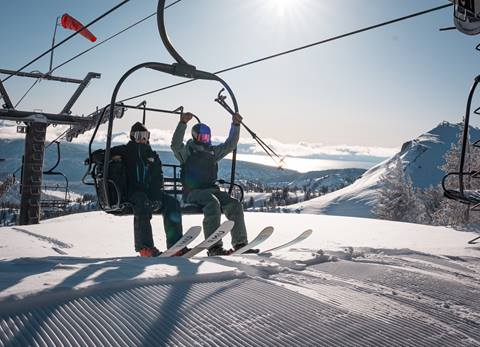 Skiers getting off the chairlift at Granite Chief