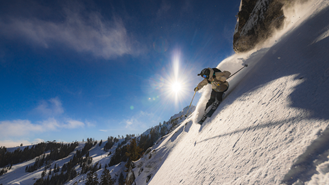 Skier sending a technical line off Granite Chief