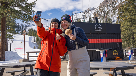 Two friends taking a selfie with their Wildflour treats
