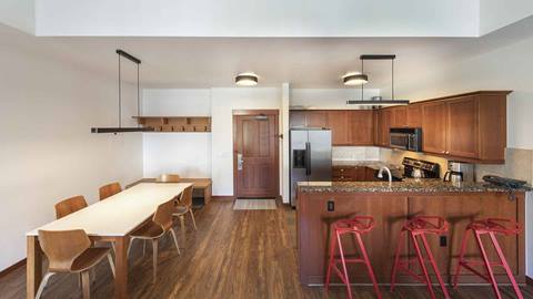 The kitchen, breakfast bar, and dining area in the Tram Face Suite.