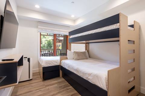 Secondary bedroom with two twin beds and a full bed