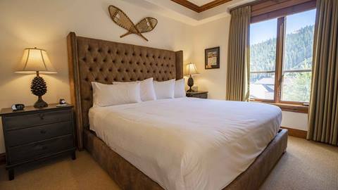 A bedroom in The Village at Palisades Tahoe looking out at the mountain.