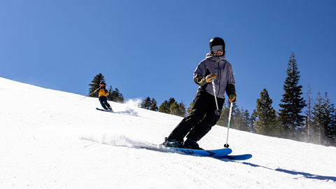 Skier making turns on groomers at Palisades Tahoe
