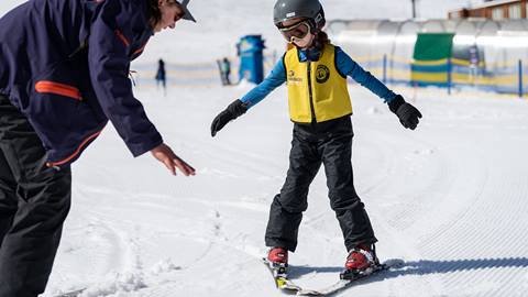 Child takes a lesson from an instructor.