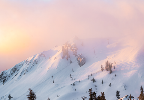 Sunrise over KT-22 lift with a mix of yellow, orange, and pink hues