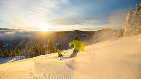 Two skiers getting in some golden hour turns