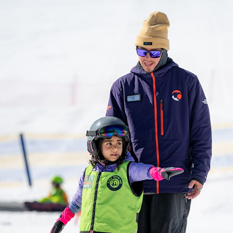 Little girl wearing a KinderVest with an instructor