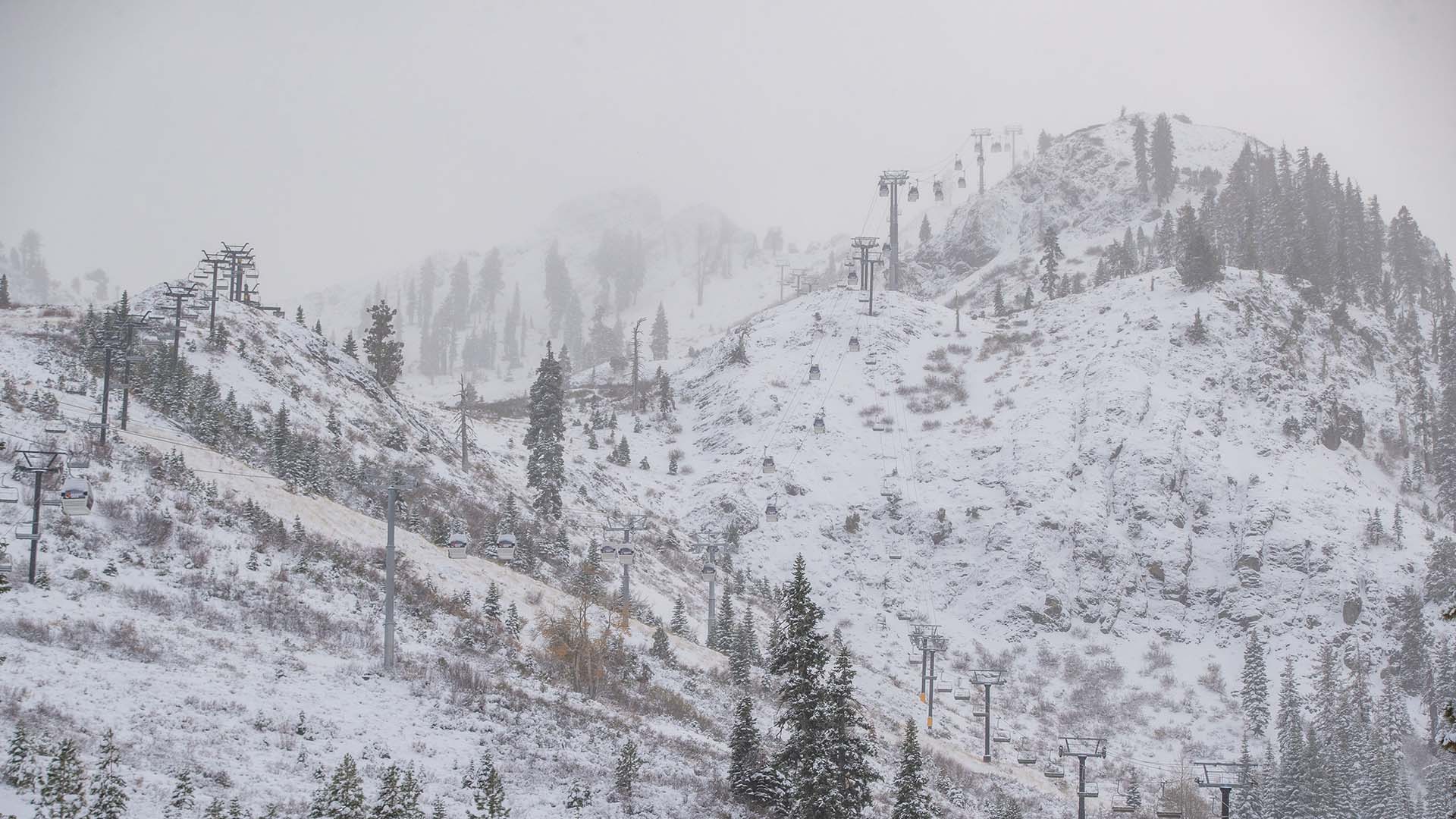 A light blanket of new snow covers KT-22 chairlift at Palisades Tahoe.